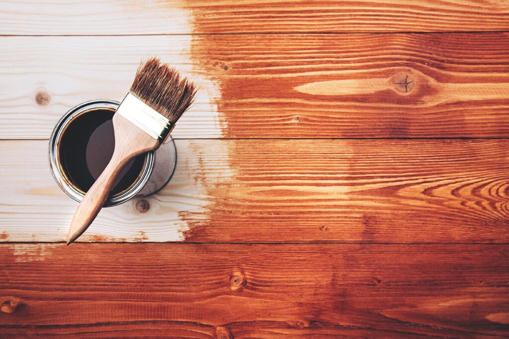 Deck staining and painting process for home improvement projects.